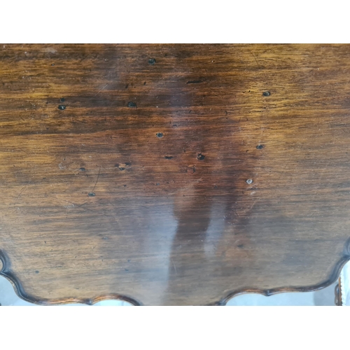 286 - A Georgian mahogany tilt-top Table with shaped dished top on fluted and spiral turned column and car... 