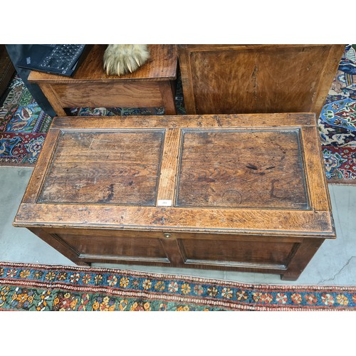 293 - A small 18th Century Oak Coffer with panelled top and front, the interior fitted Candle Box, 3ft 6in... 