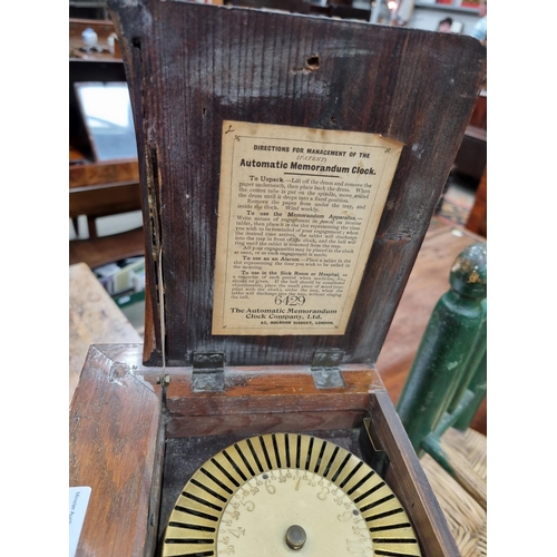 221 - An unusual late 19th Century oak and brass automatic Memorandum Clock, the hinged pediment enclosing... 