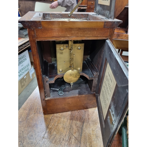 221 - An unusual late 19th Century oak and brass automatic Memorandum Clock, the hinged pediment enclosing... 