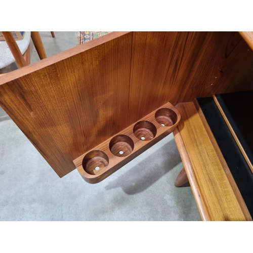 349 - A mid-century Danish teak Sideboard fitted three cupboard doors and four drawers on turned supports ... 