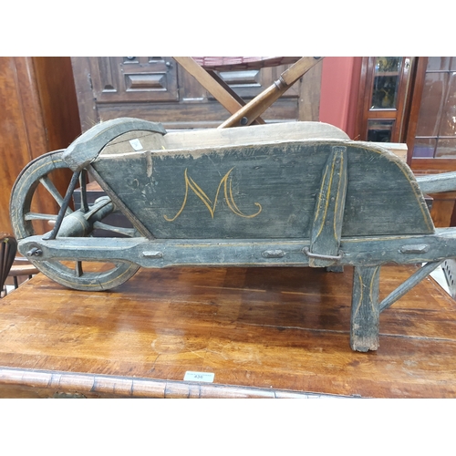 241 - A small painted wooden Wheelbarrow with gilt painted detail 4ft 7in L.