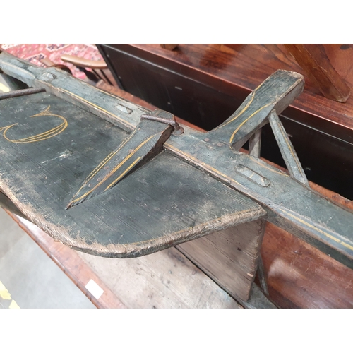 241 - A small painted wooden Wheelbarrow with gilt painted detail 4ft 7in L.