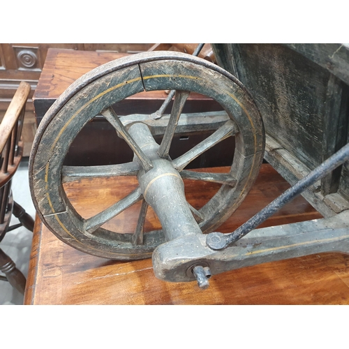 241 - A small painted wooden Wheelbarrow with gilt painted detail 4ft 7in L.