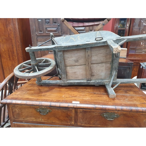 241 - A small painted wooden Wheelbarrow with gilt painted detail 4ft 7in L.