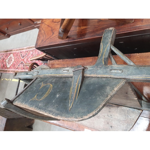 241 - A small painted wooden Wheelbarrow with gilt painted detail 4ft 7in L.