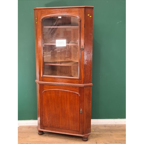 47 - A mahogany Standing Corner Cupboard with glazed top door enclosing three fitted shelves, above panel... 