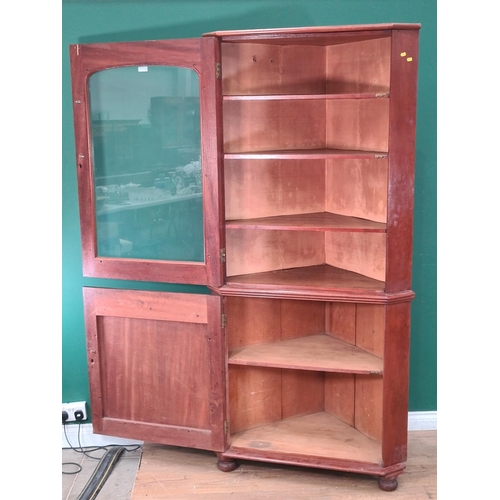 47 - A mahogany Standing Corner Cupboard with glazed top door enclosing three fitted shelves, above panel... 