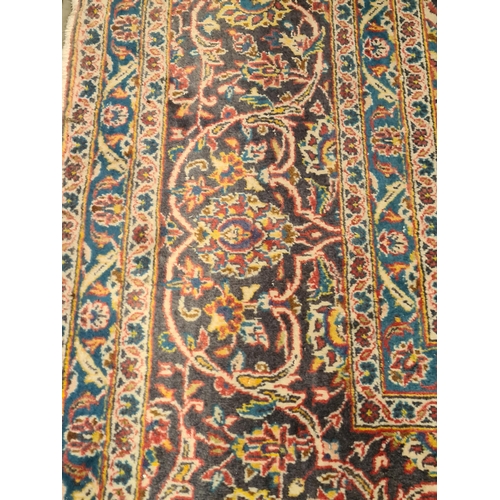 11 - A modern bordered Persian Carpet with large oval floral medallion on a red ground, palmette main bor... 