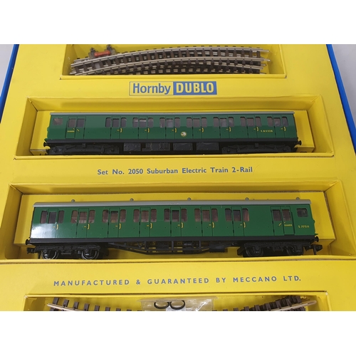 1069 - A boxed Hornby Dublo 2050 Suburban Train Set, contents M, small piece of front coupling missing. Box... 