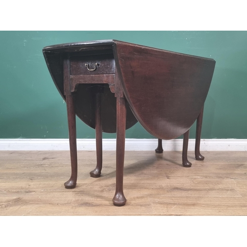 48 - A Georgian cuban mahogany Dropleaf Table with oval top, fitted frieze drawer on turned supports and ... 