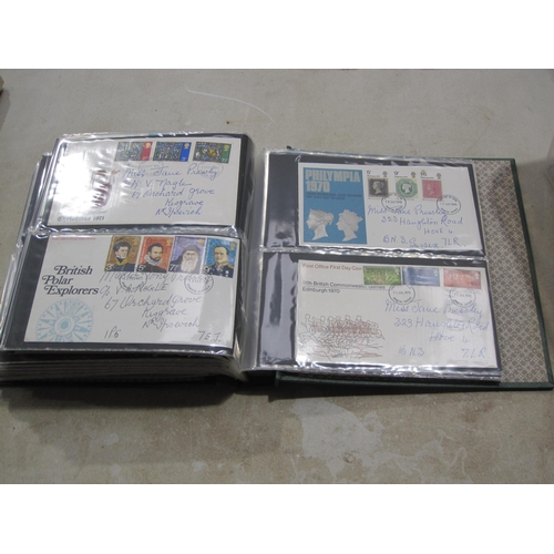 403A - An album containing approx 150 GB QE11 First day Covers; and some mint stamps in packs (qty)