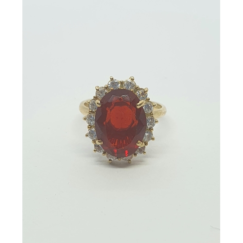 168 - A Mexican Fire Opal and Diamond Cluster Ring claw set large oval mixed-cut fire opal approx 8mm x 12... 