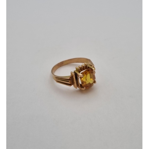 181 - A vintage Dress Ring set synthetic yellow sapphire in rose coloured gold, tests as 10ct, approx 3.10... 