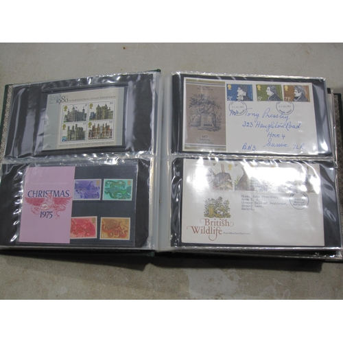 403A - An album containing approx 150 GB QE11 First day Covers; and some mint stamps in packs (qty)