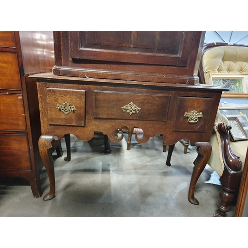 29 - A Georgian oak Lowboy fitted three drawers above shaped apron raised on cabriole front supports and ... 