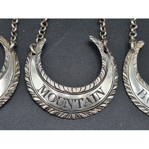 117 - Five Georgian silver crescent shape Labels with gadroon rims and chains, viz: Mountain, Madeira, Cla... 