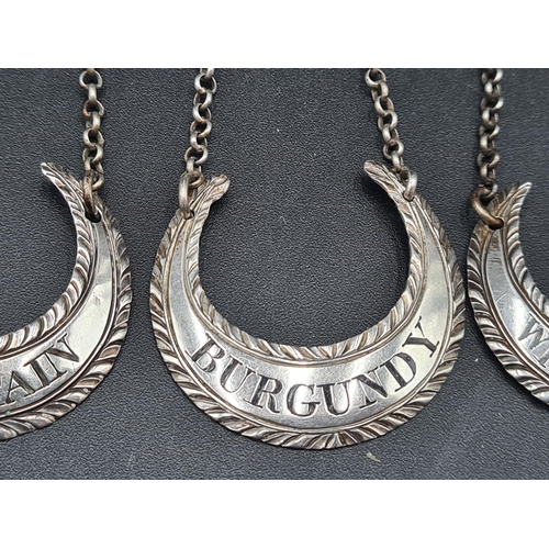 117 - Five Georgian silver crescent shape Labels with gadroon rims and chains, viz: Mountain, Madeira, Cla... 