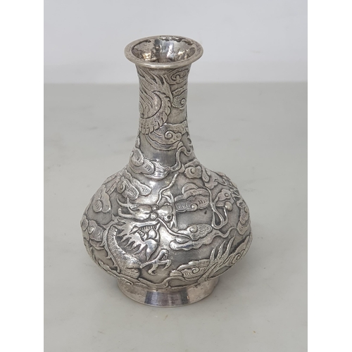 119 - A Chinese silver small club shape Vase with dragon and cloud design, 4in, character mark etc under