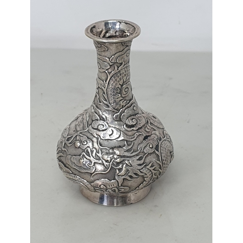 119 - A Chinese silver small club shape Vase with dragon and cloud design, 4in, character mark etc under