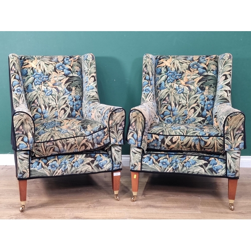 12 - A pair of wing Armchairs with hummingbirds amongst tropical foliage design upholstery raised on squa... 