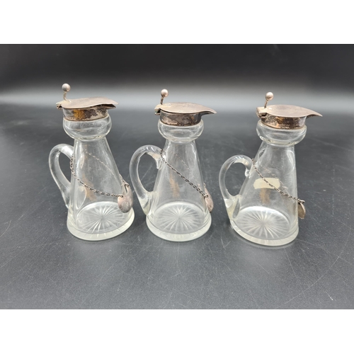 120 - Three George V silver lidded glass Toddy Flasks, Birmingham 1911 & 1915, and three Whiskey Labels, B... 