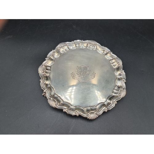 135 - A Victorian silver Card Tray of shaped circular form with scallop and scroll rim, engraved initials ... 