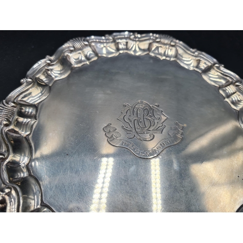 135 - A Victorian silver Card Tray of shaped circular form with scallop and scroll rim, engraved initials ... 