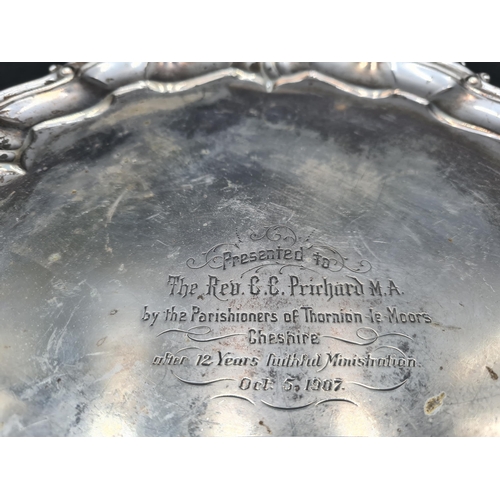 137 - An Edward VII silver Salver of shaped circular form engraved presentation inscription, on three scro... 