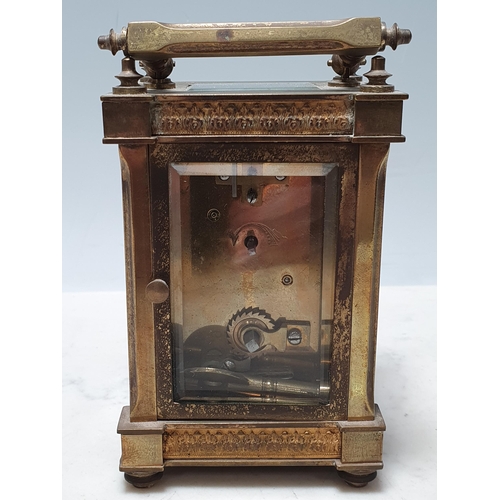 230 - A French brass Carriage Clock with circular enamel Dial, surrounded by gilt metal filigree in the st... 