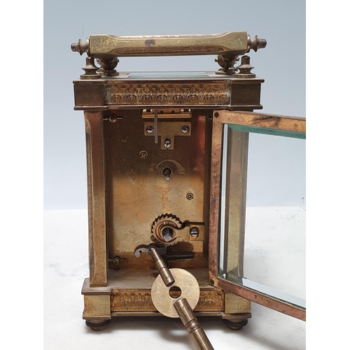 230 - A French brass Carriage Clock with circular enamel Dial, surrounded by gilt metal filigree in the st... 