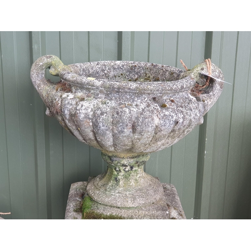 241 - A weathered Composite stone twin handled Garden Urn/Planter with ribbed design, raised on separate p... 