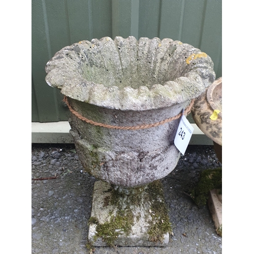 243 - A small Composite Garden Urn with flared Rim, raised on plinth base, 16