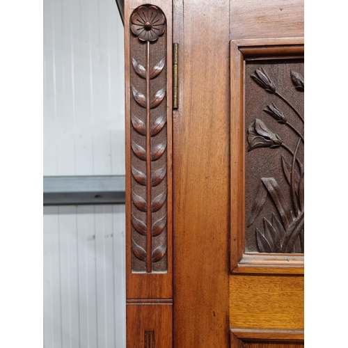 37 - An Edwardian Mirror Door Wardrobe, the moulded cornice above central mirror door, flanked by panelle... 