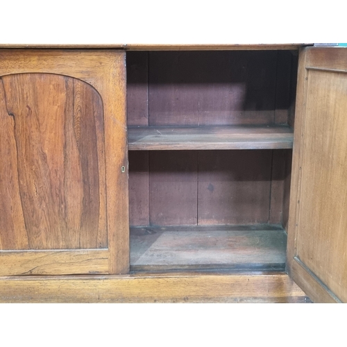 38 - A Victorian rosewood Bookcase the upper section fitted with adjustable shelves above base fitted sin... 