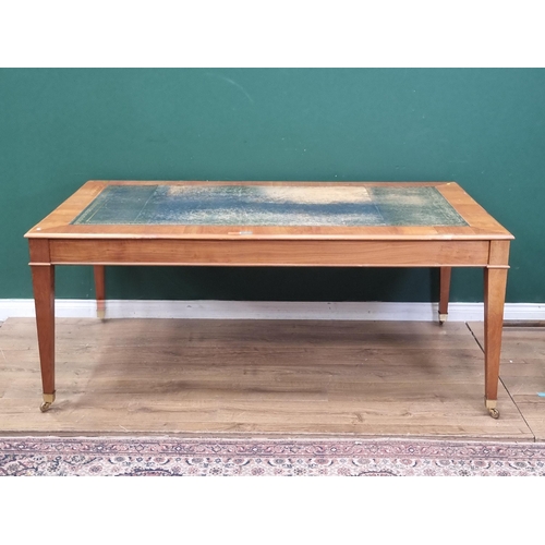 39 - A cherry wood Library Table with leather inset writing surface raised on square tapering supports an... 