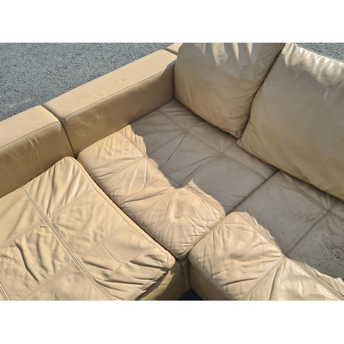 4 - A large 1970's style cream leather L shaped sectional Lounge Suite. (R11).