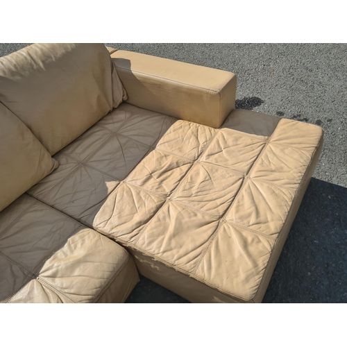 4 - A large 1970's style cream leather L shaped sectional Lounge Suite. (R11).