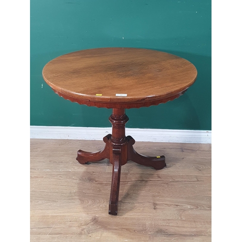 40 - A Victorian oak Pillar Table with circular top having shaped apron on turned supports and tripod bas... 