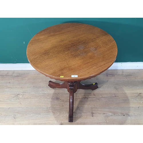 40 - A Victorian oak Pillar Table with circular top having shaped apron on turned supports and tripod bas... 