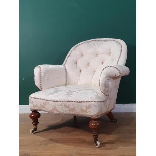 44 - A Victorian cream button upholstered Armchair on turned walnut supports and ceramic casters 2ft 8in ... 