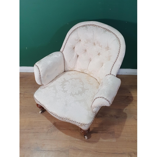 44 - A Victorian cream button upholstered Armchair on turned walnut supports and ceramic casters 2ft 8in ... 