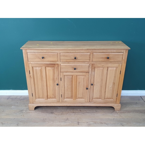 474 - A modern oak Sideboard fitted three drawers above four panel doors 4ft 6in W x 3ft 2in H (R6)