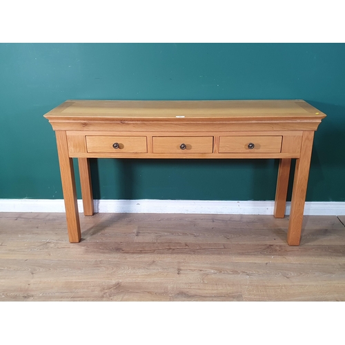 484 - A modern oak Side Table fitted three frieze drawers raised on square supports 4ft 11in W x 2ft 8in H... 