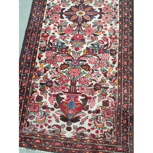 532 - A cream ground woollen Rug with stylised floral design 7ft L x 2ft 9in W and a red ground Prayer Rug... 