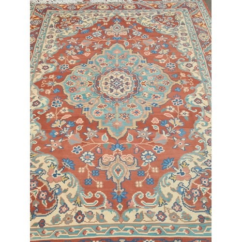 536 - A red ground woolen Rug with pale blue central lozenge with floral design within tramline borders 9f... 