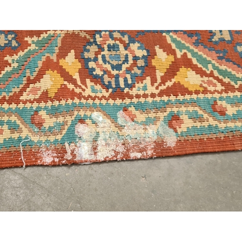 536 - A red ground woolen Rug with pale blue central lozenge with floral design within tramline borders 9f... 