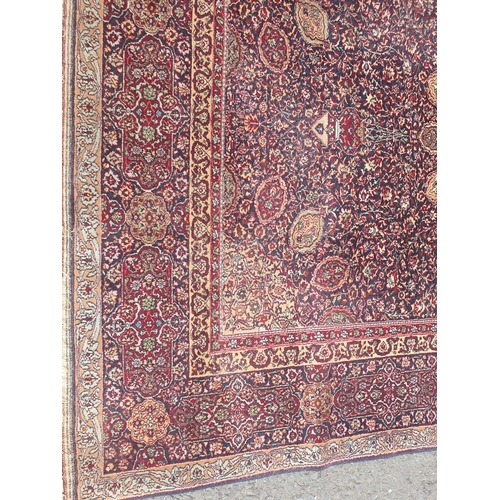 539 - A Persian style Rug with intricate trailing foliate design on purple ground 9ft 2in L x 6ft 2in W (R... 