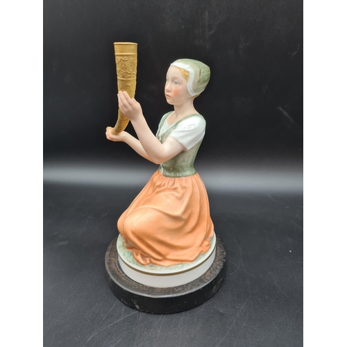 54 - A Copenhagen Figure of a young lady holding a gilt decorated curved horn, on circular base, 8 1/2in ... 