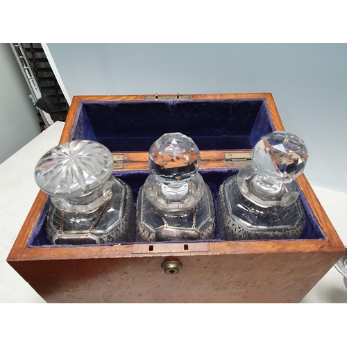 548 - An oak Decanter Box by Albert Baker Ltd, containing three decanters with plated labels,  14in W and ... 